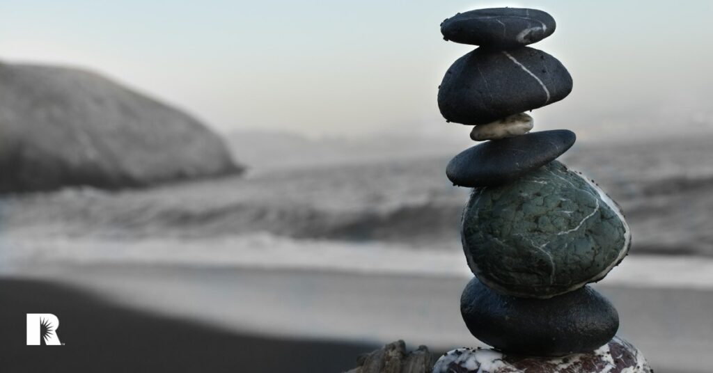 A stack of rocks balanced on a beach, to illustrate balance.