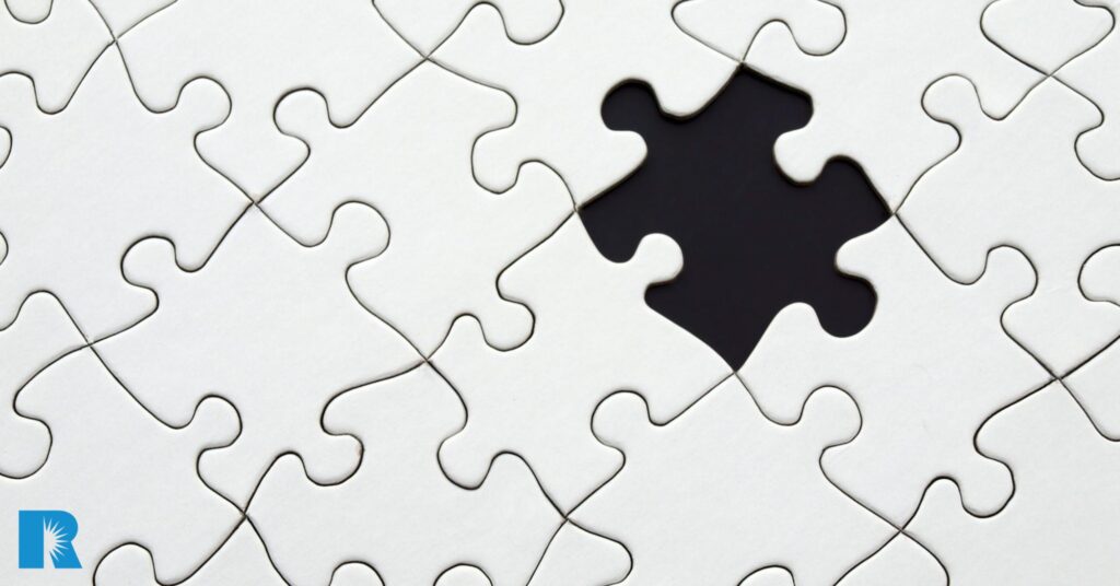Image of a white puzzle with a key piece missing.